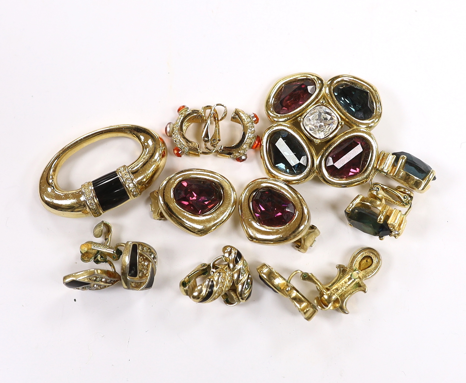 A Christian Dior gilt metal and coloured paste set quatrefoil brooch, 37mm and pair of similar ear clips, five other assorted pairs of Dior ear clips and a Dior brooch.